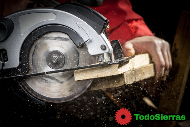 Close-up of carpenter cutting a wooden plank